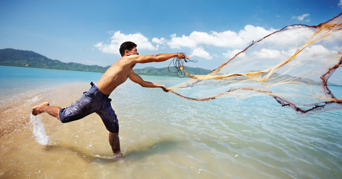 a man is cast net fishing